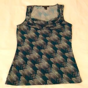 Sleeveless blouse with front drape in deep green, gray and black.